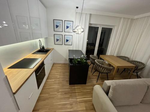 a kitchen and a living room with a table at Apartamenty Cieszyn in Cieszyn