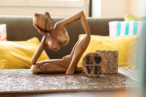 a wooden statue of a dog sitting on a table at Special MODERN LiSA Apartment Basel, Bahnhof Grossbasel 10-STAR in Basel