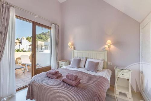 a bedroom with a bed with towels on it at La Manga Club - Monte Claro 606 in Atamaría