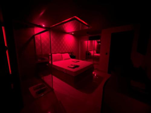 um quarto vermelho com uma cama e um espelho em Prestige Motel 1 em São Paulo