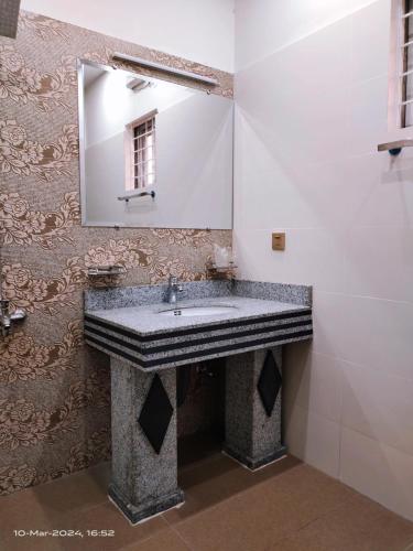 a bathroom with a sink and a mirror at VIP Luxury Room's in Lahore