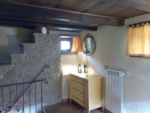 a room with a sink and a stone wall at Torre Riva Dimora storica in Fiumalbo