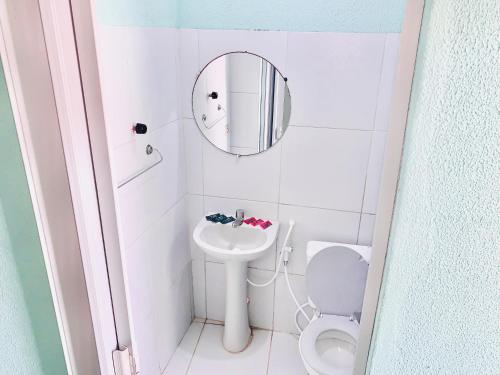 a small bathroom with a toilet and a mirror at Flats e Suítes Elcaline in Porto De Galinhas
