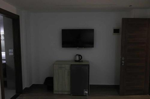 a room with a flat screen tv on a wall at elhosary motel in 6th Of October