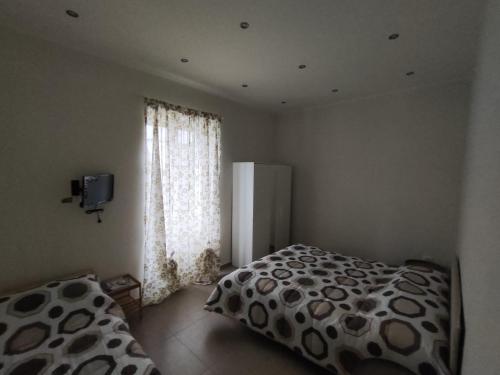 a bedroom with a bed and a large window at A Casa di Nonna Anna in Ercolano