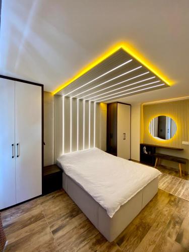 a bedroom with a large white bed and a mirror at Hotel Customised flat Near Taksim/Nişantaşi in Istanbul