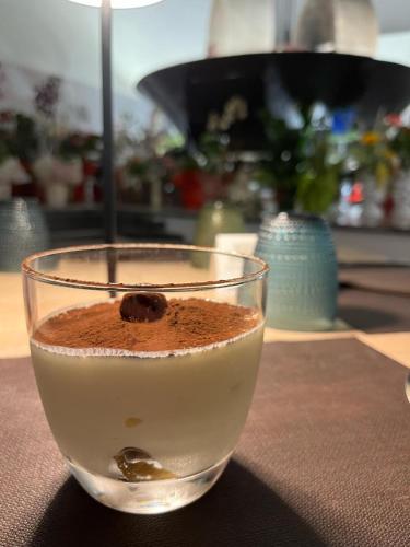 a drink in a glass sitting on a table at B&B Del Centro e SPA in Partinico