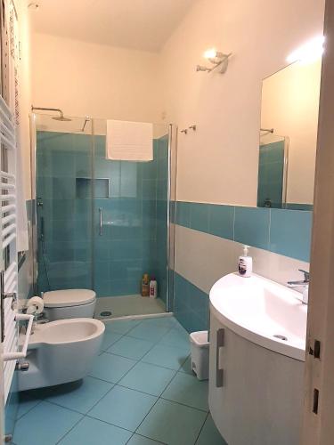 a bathroom with a sink and a toilet and a shower at Cairoli Home in Rapallo