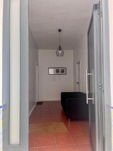 a view of a living room with a black couch at Imperial Douro Apartamento 1 in Peso da Régua