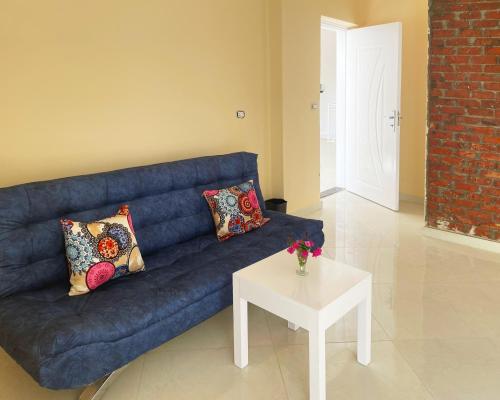 a blue couch with pillows and a table in a living room at Karima House in Luxor