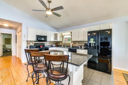 a kitchen with white cabinets and bar stools at Watts Bar Lake Escape Private Boat Dock and Ramp! in Spring City