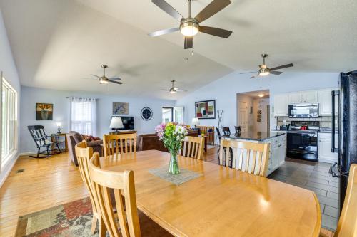 a dining room and living room with a table and chairs at Watts Bar Lake Escape Private Boat Dock and Ramp! in Spring City