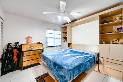 a bedroom with a bed and a dresser at Waterfront Marco Island Condo Less Than quarter Mi to Beach! in Marco Island