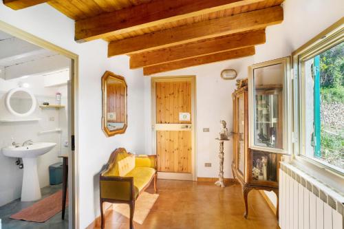 sala de estar con sofá amarillo y lavamanos en House of silence en Badalucco