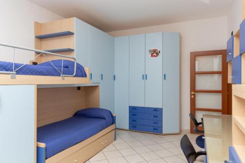 a bedroom with two bunk beds with blue sheets at ArtStay Exclusive Apt Linate, Parking, Terrace AC in Pioltello