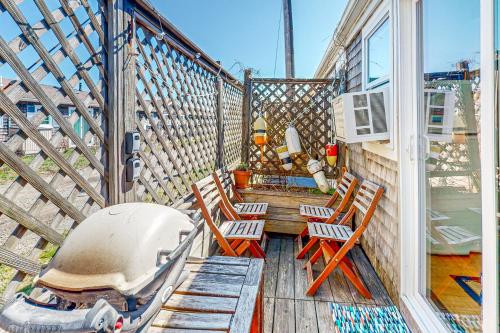 a balcony with chairs and a boat on it at Cozy Cape Condo in Provincetown
