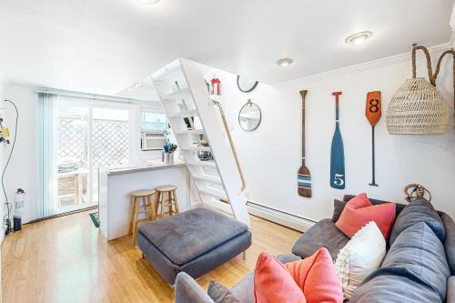 a living room with a couch and a kitchen at Cozy Cape Condo in Provincetown