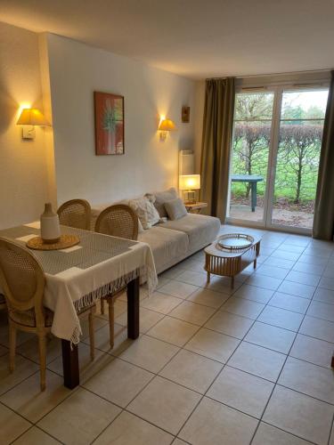 a living room with a couch and a table at Charm Burgundy in Levernois