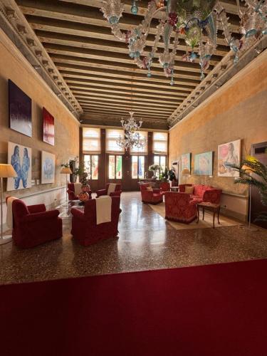 a large living room with couches and chairs at Ruzzini Palace Hotel in Venice