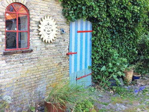 a blue door on the side of a brick building at 10 person holiday home in S nderborg in Sønderborg