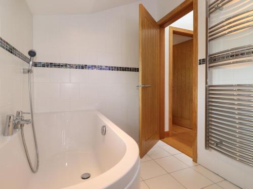 a white bathroom with a tub and a shower at Jaycot in Alston