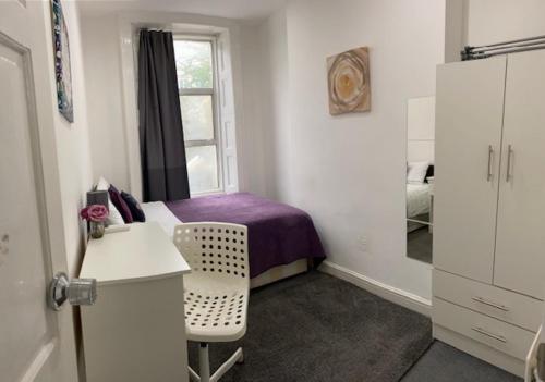 a small bedroom with a bed and a window at LORD MERIT GUEST HOUSE KING'S CROSS GRAYS INN ROAD in London