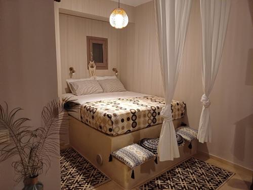 a bedroom with a bed with a curtain at Pallos studio in Órmos Koumaíïkon