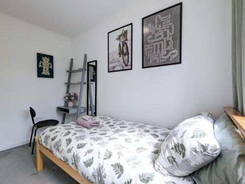 a bedroom with a bed and some pictures on the wall at Guest Rooms Near City Centre & Dock Free Parking in Liverpool