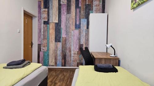 a room with two beds and a desk and a wall at 3611 HAUS HABRUCK Top 2 F in Habruck