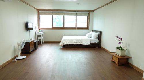 a large room with a bed and a window at Happy Memory in Jeonju