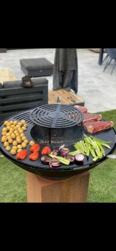 a grill with different types of vegetables on it at Magnifique chalet en bois avec piscine et jacuzzi in Court-Saint-Étienne