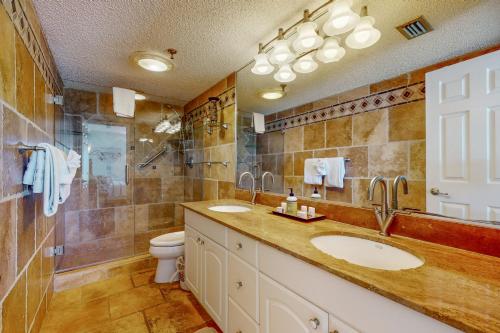a bathroom with two sinks and a shower at Sunset Shores in St Pete Beach