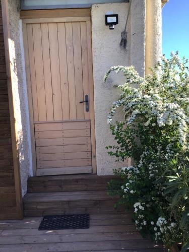 a wooden door on a house with a staircase at La maison Anaïa in Gargas