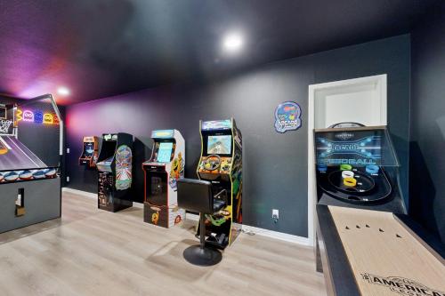 a room with four video game machines in it at The Beach Bunkhouse in Pacific City
