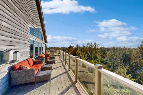 a deck with couches and chairs on a house at The Beach Bunkhouse in Pacific City