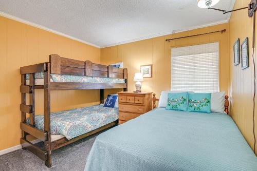 a bedroom with two bunk beds and a dresser at Coastal Condo on Beach with Community Pool Access! in Myrtle Beach