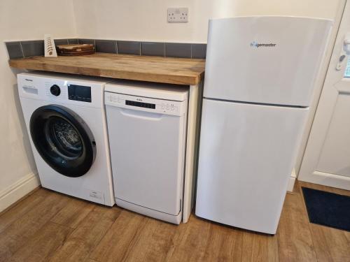 a white refrigerator and a washing machine in a kitchen at West Beck House Newcastle - Spacious Double Room in North Shields