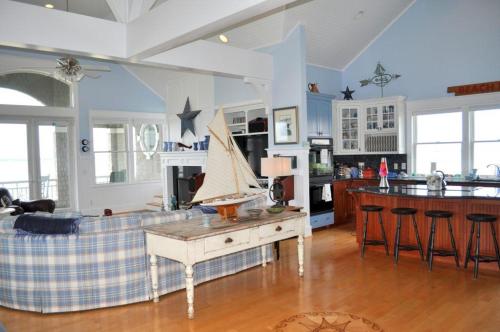 a kitchen and living room with a boat on a table at Journeys End in Southport