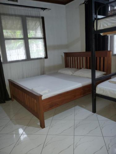 a bedroom with two bunk beds and two windows at Nest Haven Homestay-Hostel in Dar es Salaam