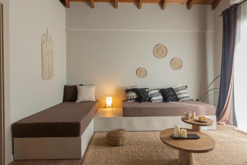 a living room with two beds and a table at Poesia Suites in Lakithra