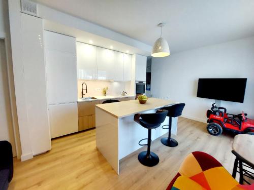 a kitchen with a desk and chairs in a room at Luxury modern new apartment with garden close to Wroclaw self check-in 24h in Siechnice