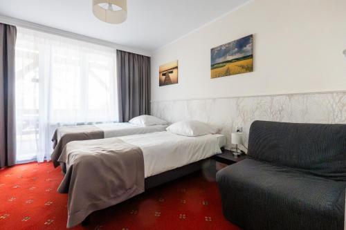 Voodi või voodid majutusasutuse Hotel Tajty toas