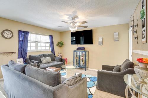 a living room with couches and a ceiling fan at 5 Mi to Beach Family-Friendly Home in Clearwater! in Clearwater