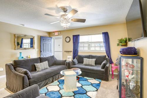 a living room with two couches and a ceiling fan at 5 Mi to Beach Family-Friendly Home in Clearwater! in Clearwater
