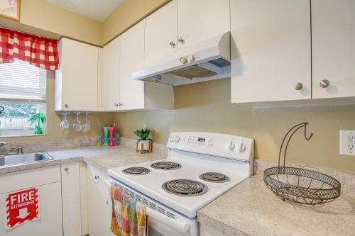 a kitchen with a white stove and a sink at 5 Mi to Beach Family-Friendly Home in Clearwater! in Clearwater
