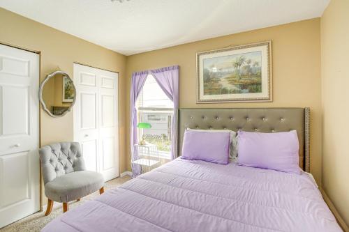 a bedroom with a purple bed and a chair at Colorful Clearwater Home about 5 Mi to the Beach! in Clearwater