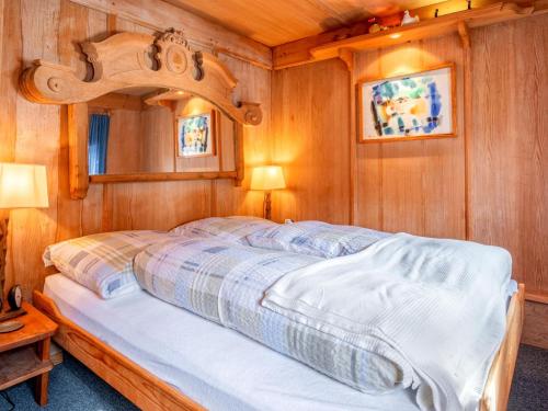 a bedroom with a bed in a wooden room at Zinnhäusel in Alpbach