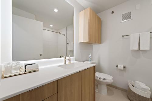 a white bathroom with a sink and a toilet at Coffe bar + spa + Lounge + Golf at Lincoln Park-1475-By Cloud9 in Chicago