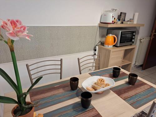 a table with a bowl of food on it at Holidays at the Dock - Fiumicino Airport in Fiumicino
