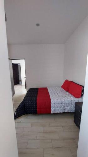 a bedroom with a bed with red pillows on it at León Casa Privada Benevento Estadio+Explora+Feria in Sofía